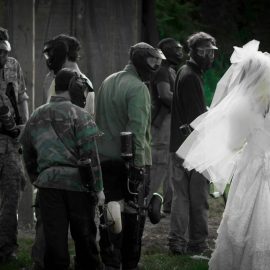 bride in gown with paintball players